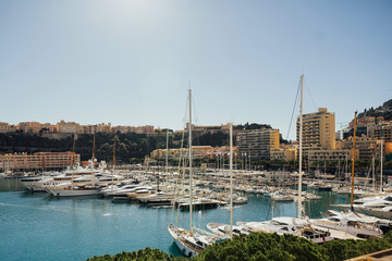 Landscape view on the bay with luxury yachts on the french riviera in Monte Carlo in Monaco. Cityscape, principality harbor view. Skyscrapers and marina. Azure coast. France, Europe.