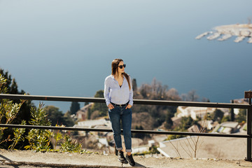 Fototapeta na wymiar Tender woman enjoying scenic view to the lake Lugano from mountain San Salvatore in Lugano, canton of Ticino, Switzerland. She on a view point. Travel.