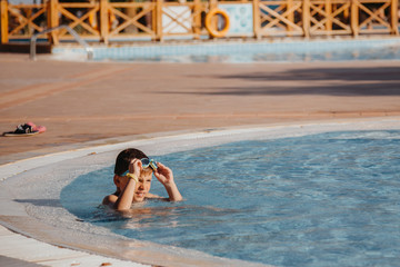 Little boy having fun in the swimming pool