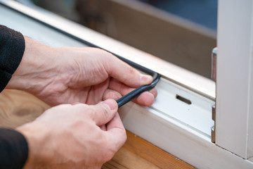 Professional master at repair and installation of windows, changes rubber seal gasket in pvc windows
