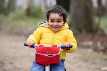 young child biking in a park