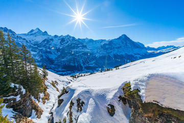 Winter landscape with snow covered peaks seen from the First mountain in Swiss Alps in Grindelwald ski resort, Switzerland