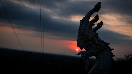 silhouette of a man on top of mountain at sunset