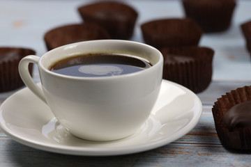 morning cup of coffee  and chocolate candies  and on the table