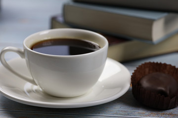 morning cup of coffee, chocolate and books and on the table