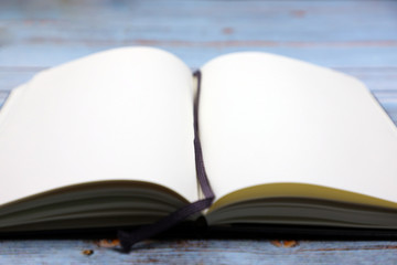 open note book on wooden table