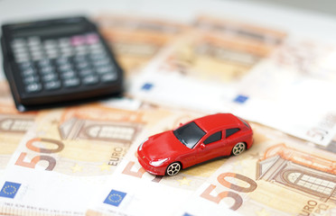 Toy car, money and calculator