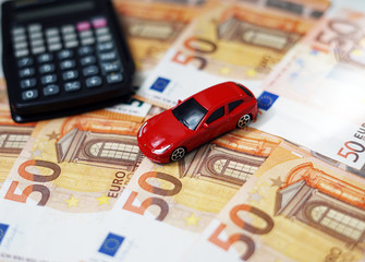 Toy car, money and calculator