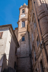 HIstorical center of Corinaldo with stone houses, chucrh, steps and flowers