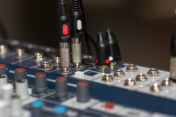 Fototapeta na wymiar Sound mixer. Close-up. The hand on the remote controls.