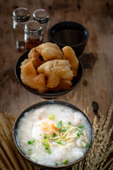 Homemade Thai breakfast, rice porridge and chinese donut on vintage wooden floors