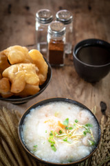 Homemade Thai breakfast, rice porridge and chinese donut on vintage wooden floors