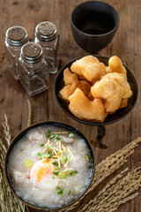 Homemade Thai breakfast, rice porridge and chinese donut on vintage wooden floors