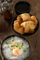 Homemade Thai breakfast, rice porridge and chinese donut on vintage wooden floors