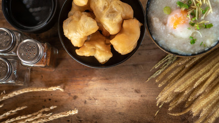 Homemade Thai breakfast, rice porridge and chinese donut on vintage wooden floors
