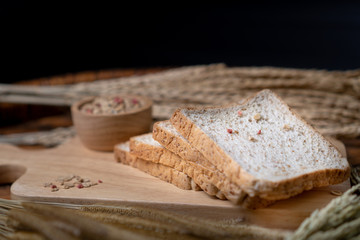 Homemade whole wheat bread, beautifully decorated on a wooden chopping board