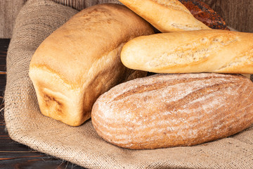 baked bread and baguette on wooden table background