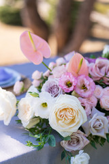 Bouquets of fresh flowers decoration of the festive table. Celebrating an open air party. Decor Details