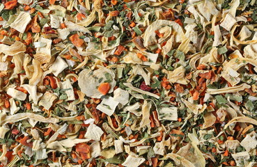 Dry cut and chopped up vegetables mix, spice background and texture, uncooked and top view