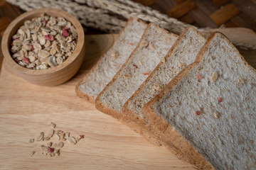 Homemade whole wheat bread, beautifully decorated on a wooden chopping board