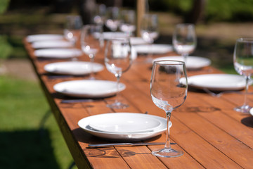 Served wooden table without a tablecloth. Cafe in the open air park