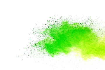 Green and yellow powder explosion on white background.