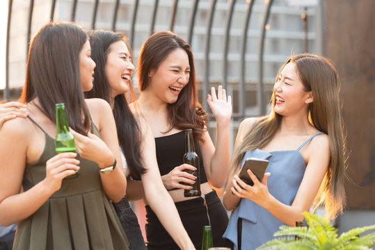happy asian women party with beer in nightclub
