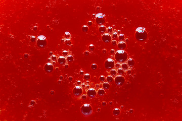 Fresh organic tomatoes juice with bubbles macro close up. Red liquid texture