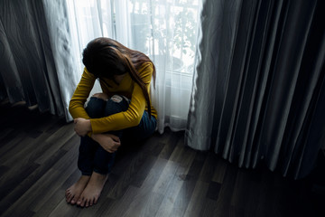 Sad young woman sitting in the bedroom, People with depression concept. - obrazy, fototapety, plakaty