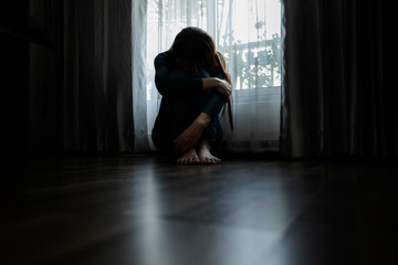 Sad young woman sitting in the bedroom, People with depression concept.	