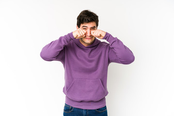 Fototapeta premium Young man isolated on white background whining and crying disconsolately.