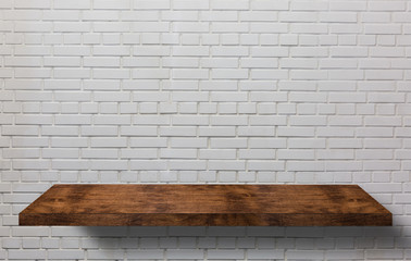 Empty wooden table for product display over grunge brick wall