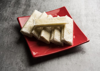 Pootharekulu  is a popular recipe originated from Andhra Pradesh, India.It is a paper-thin sweet or dessert made from rice start/gram flour, jaggery/sugar and clarified butter. Served in a plate.