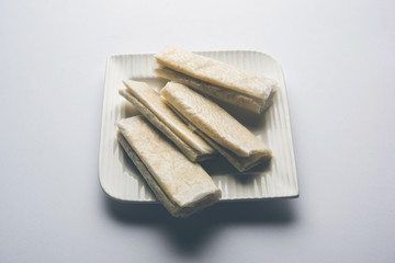 Pootharekulu  is a popular recipe originated from Andhra Pradesh, India.It is a paper-thin sweet or dessert made from rice start/gram flour, jaggery/sugar and clarified butter. Served in a plate.