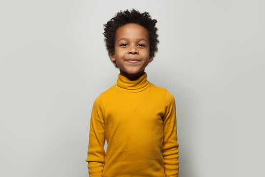 Little black child boy smiling on white background