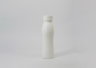 Close up of a white plastic bottle on gray background
