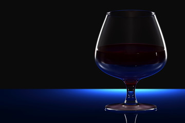 Glass goblet with wine on a mirror surface on a black background.