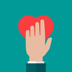 Obraz premium Hand holding red heart on blue background. charity, philanthropy, giving help