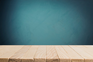 Empty wooden deck table over mint wallpaper background