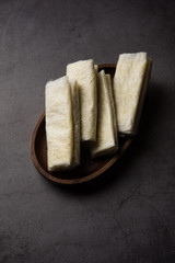 Pootharekulu  is a popular recipe originated from Andhra Pradesh, India.It is a paper-thin sweet or dessert made from rice start/gram flour, jaggery/sugar and clarified butter. Served in a plate.