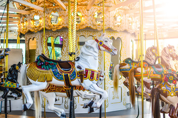 Fototapeta na wymiar Carousel horses sitting empty at an indoor merry go round in Spokane, Washington
