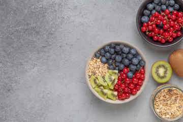 Healthy delicious Breakfast. Muesli with blueberries, red currants, kiwi and yogurt.
