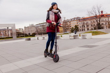 woman riding electric scooter in the city