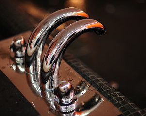 Wasting with water. Close-up of tap in bathroom - obrazy, fototapety, plakaty
