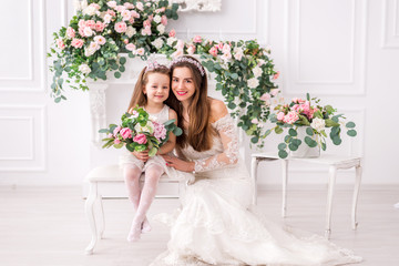 bride mother and daughter in white dresses with flowers