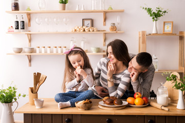 Family with child in kitchen having breakfast