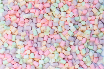 Top View of Pastel Shaped Marshmallow Candies with Some Scattered on the Pale white Table