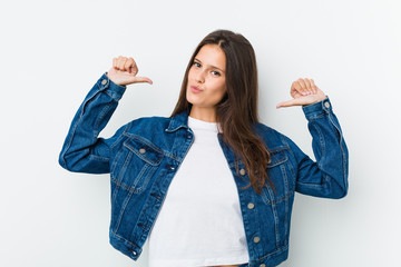 Young cute woman feels proud and self confident, example to follow.