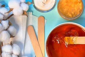 set of means of hair removal on a blue background. Wax strips. Minimalism, choice. top view, flatlay photo