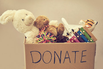 Donation box with children toys. woman collects toys for charity.